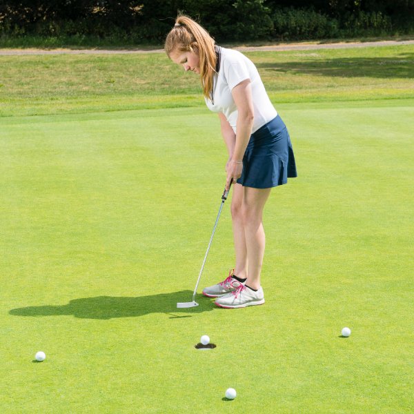 Golfer practicing putting