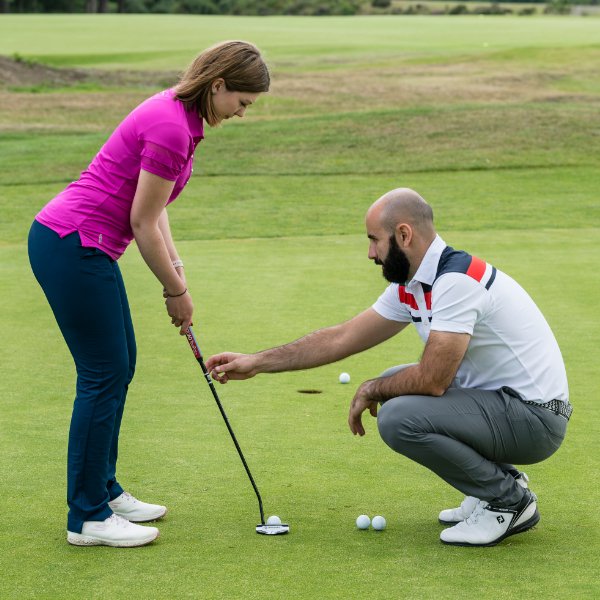 Golfer having a putting lesson